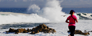 Female Runner along the Rugged Coast